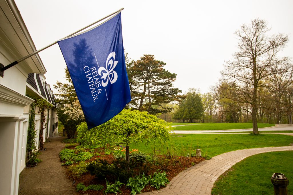 Blue Relais & Châteaux flag hanging outside of Langdon Hall