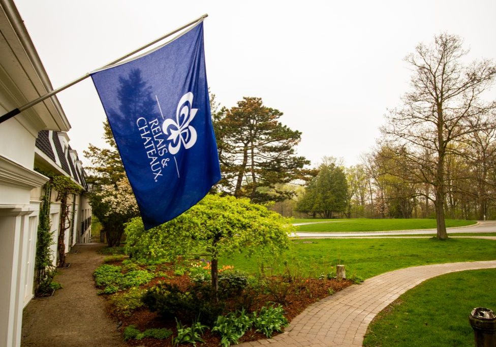 Blue Relais & Châteaux flag hanging outside of Langdon Hall
