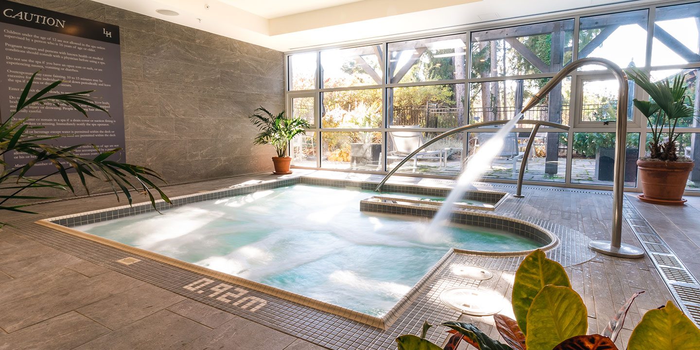 Sunrising through large windows, overlooking a spa pool